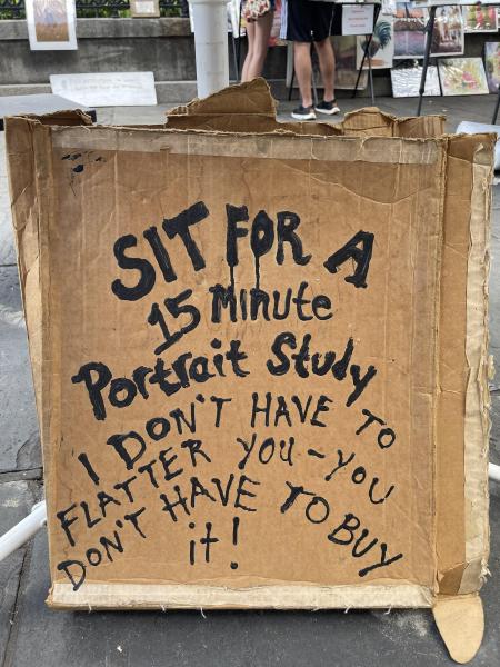 Cardboard sign about 15 minute portraits